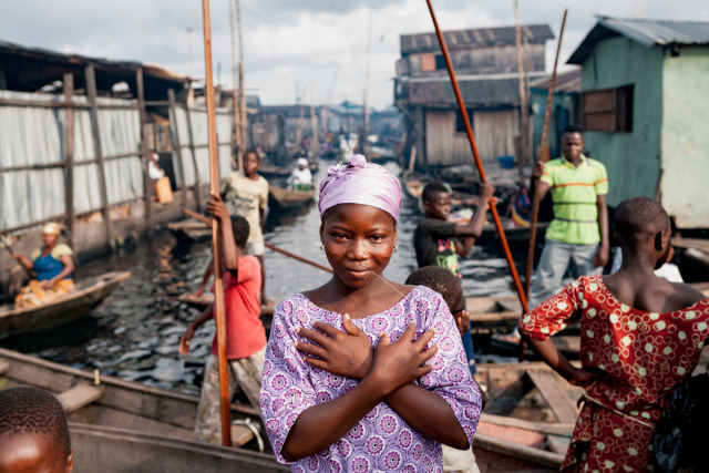  A girl poses in a slum built on stilts in the Lagos Lagoon called Makoko. gallery